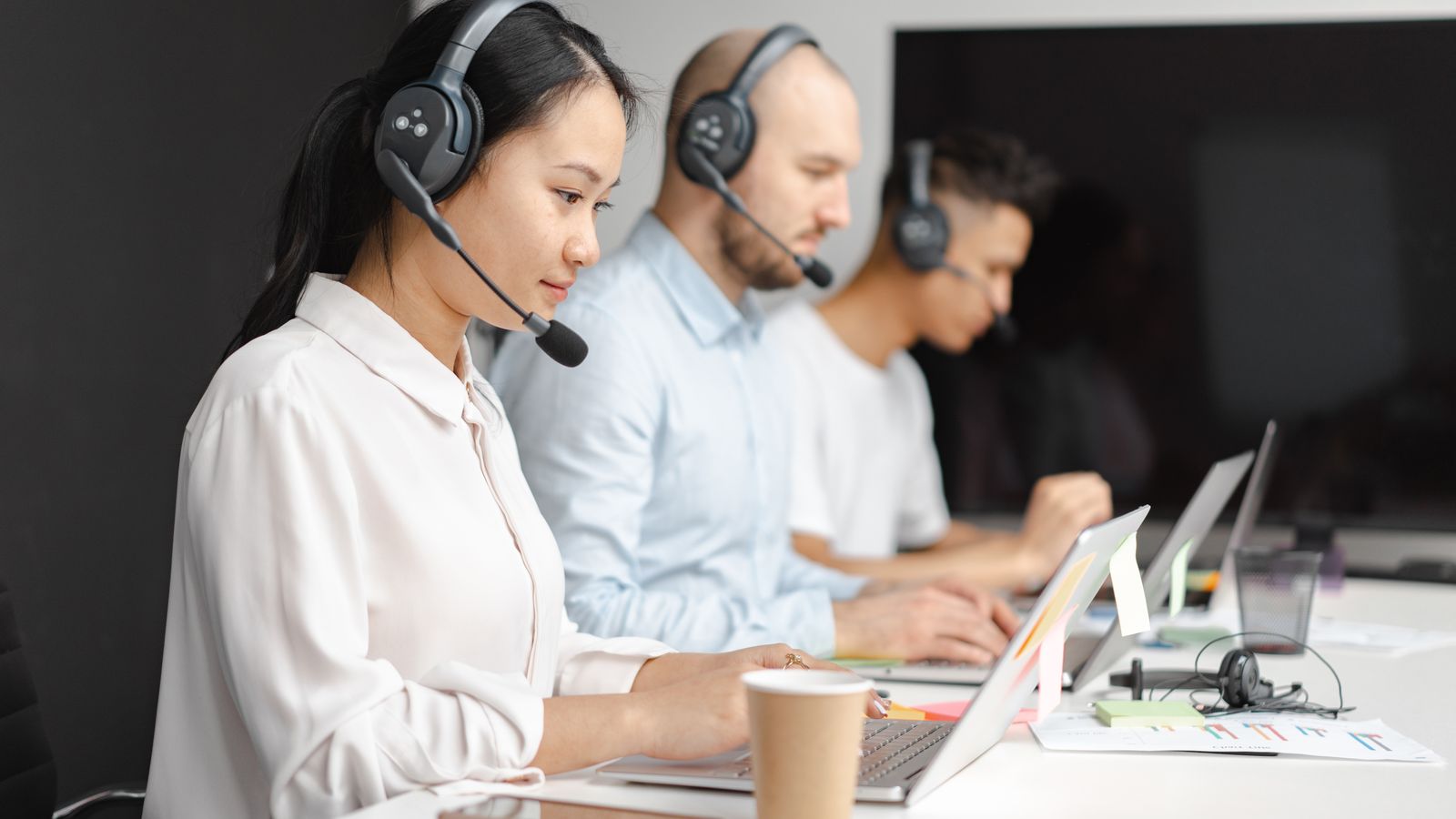 Call center team wearing headsets at their desks